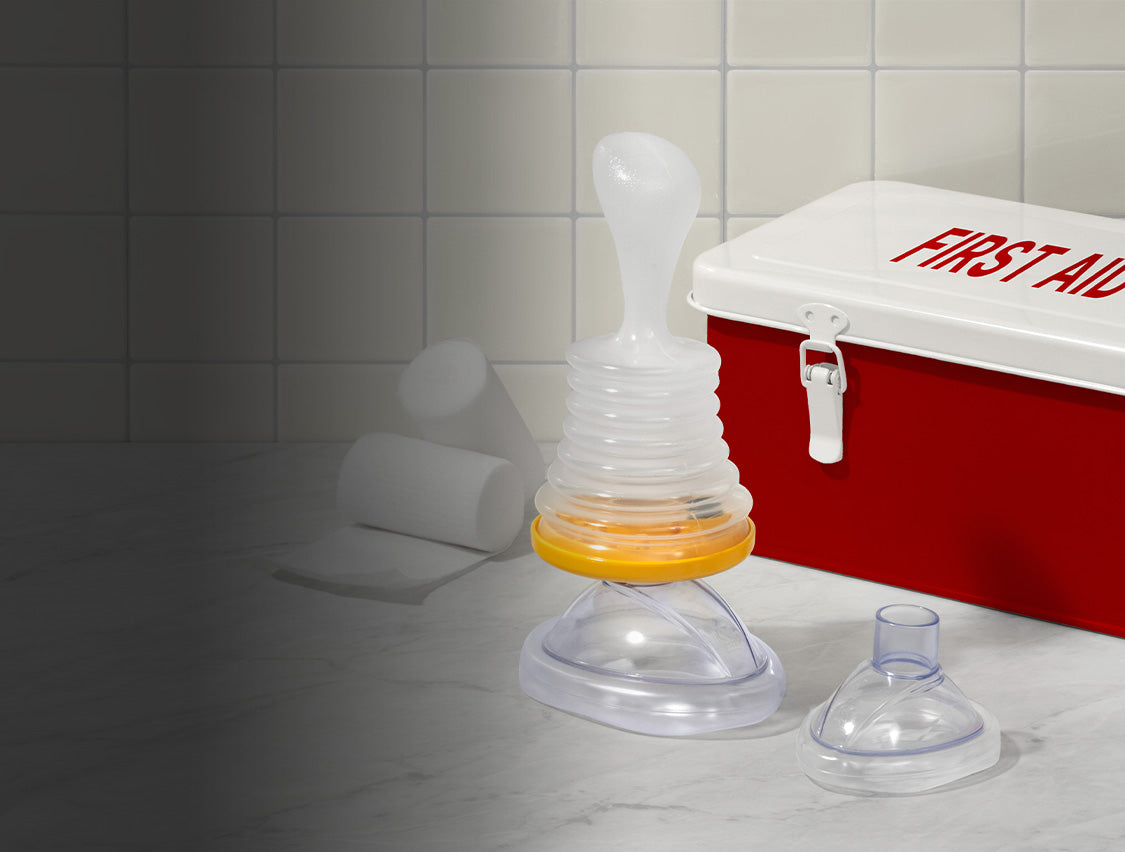 LifeVac on marble countertop in front of first aid kit and gauze